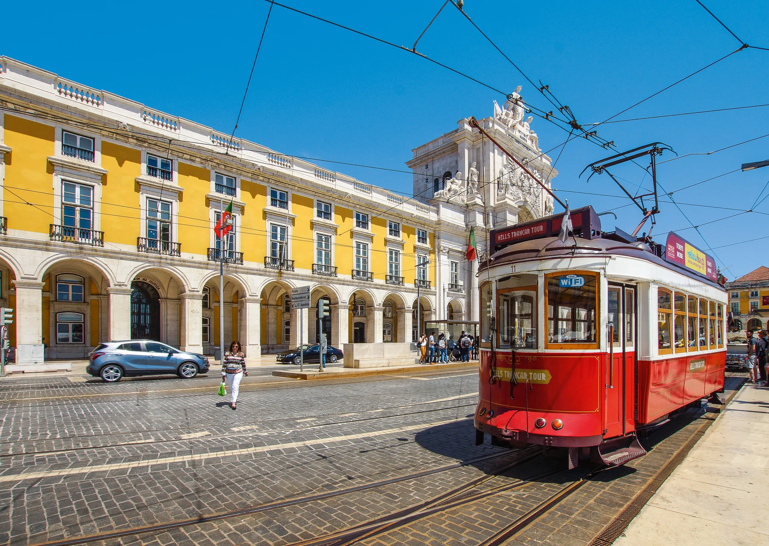 Traditional yellow tram in historic Lisbon streets
